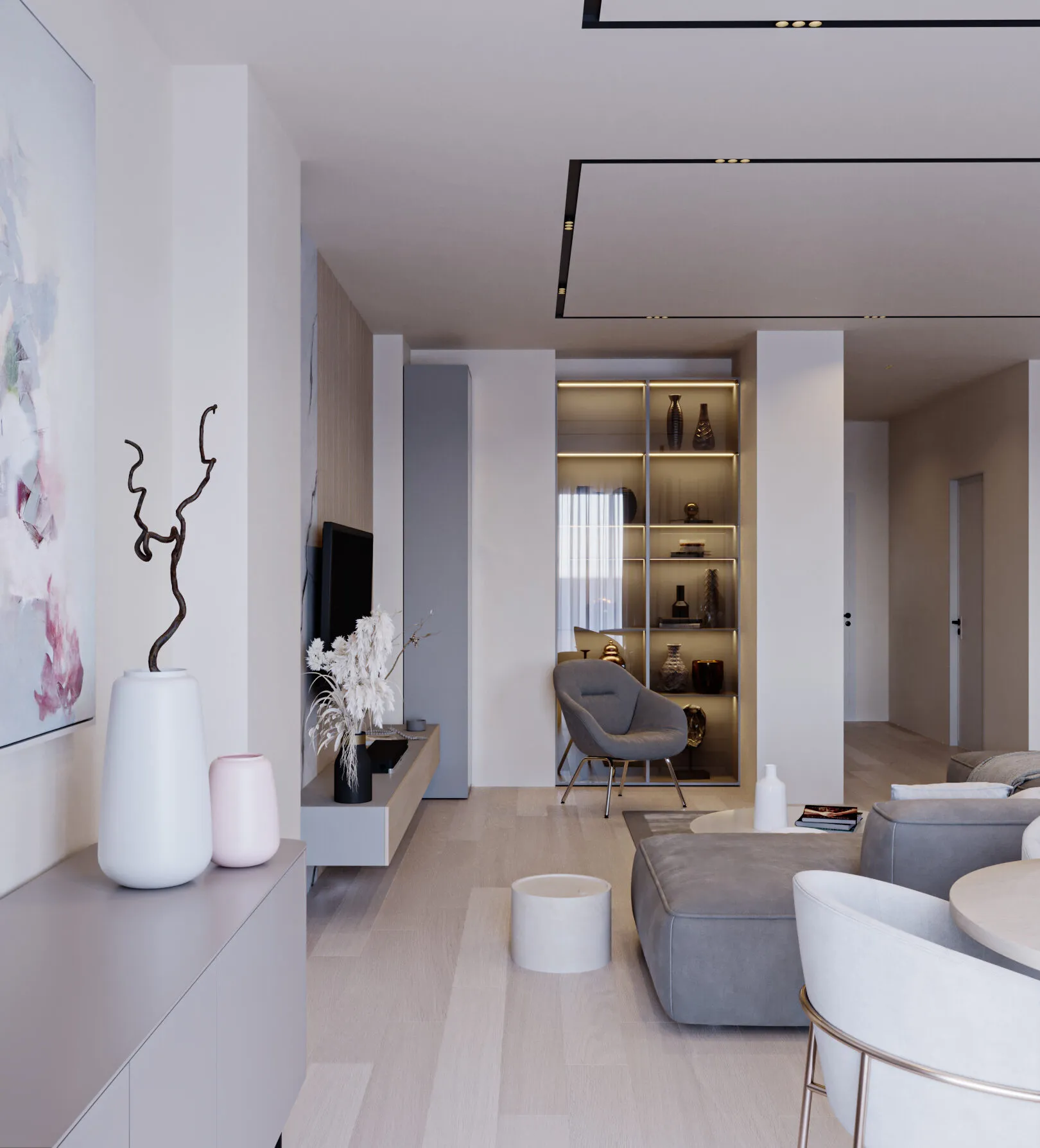 Bright living room with a grey sectional sofa, white sculptural vase and backlit shelving.