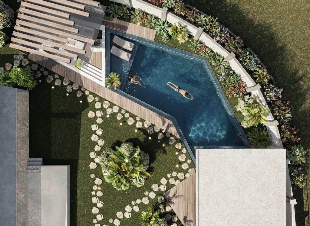 Aerial view of an angular swimming pool set into lawn, with a curving path of round stepping stones and a timber pergola.